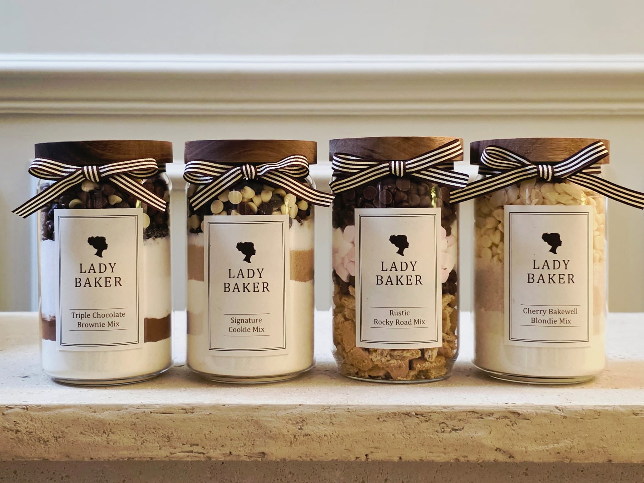 Lady Baker baking jar collection - premium cookie, brownie and blondie mixes displayed in glass jars with ribbon packaging.