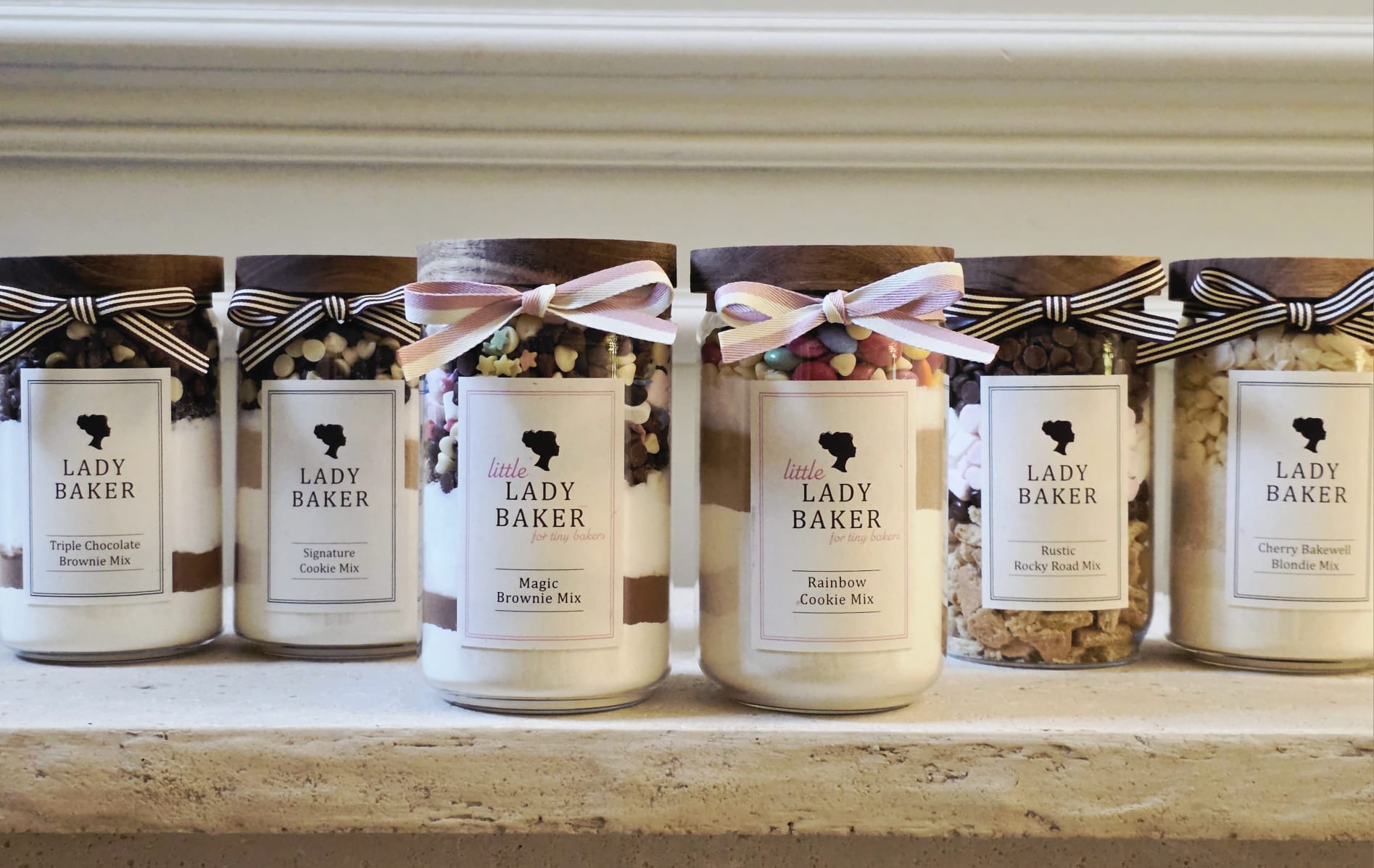 Lady Baker baking jar collection - premium cookie, brownie and blondie mixes displayed in glass jars with ribbon packaging.