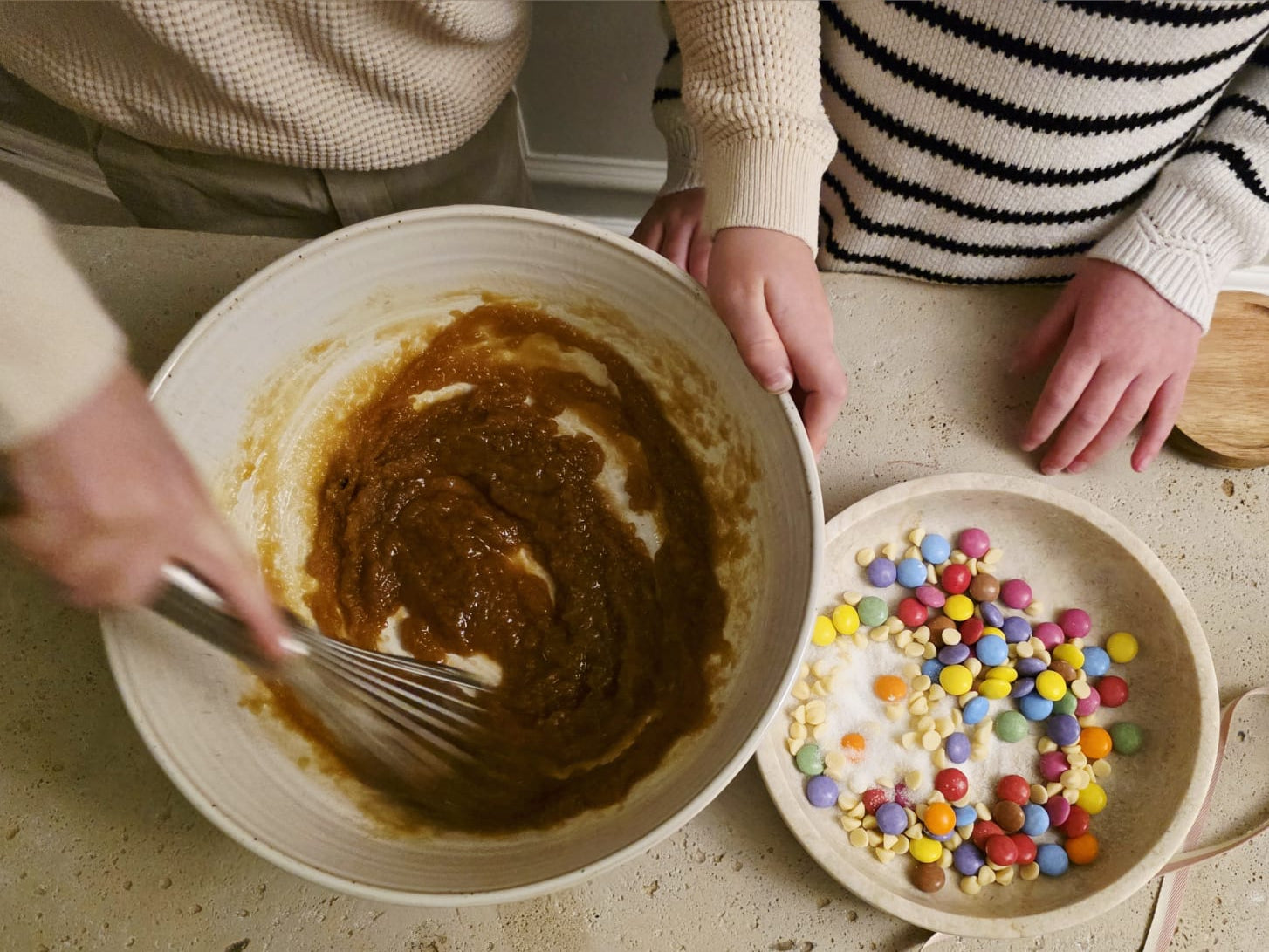 Kids mixing cookie dough for Little Lady Baker Rainbow Cookie Mix with colourful chocolate sweets ready to add