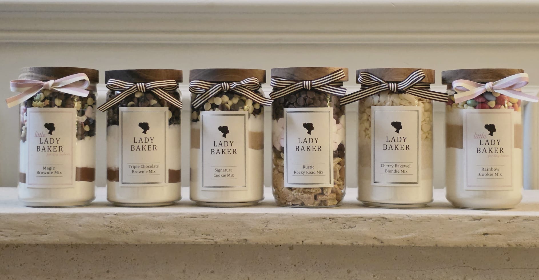 Lady Baker baking jar collection - premium cookie, brownie and blondie mixes displayed in glass jars with ribbon packaging.